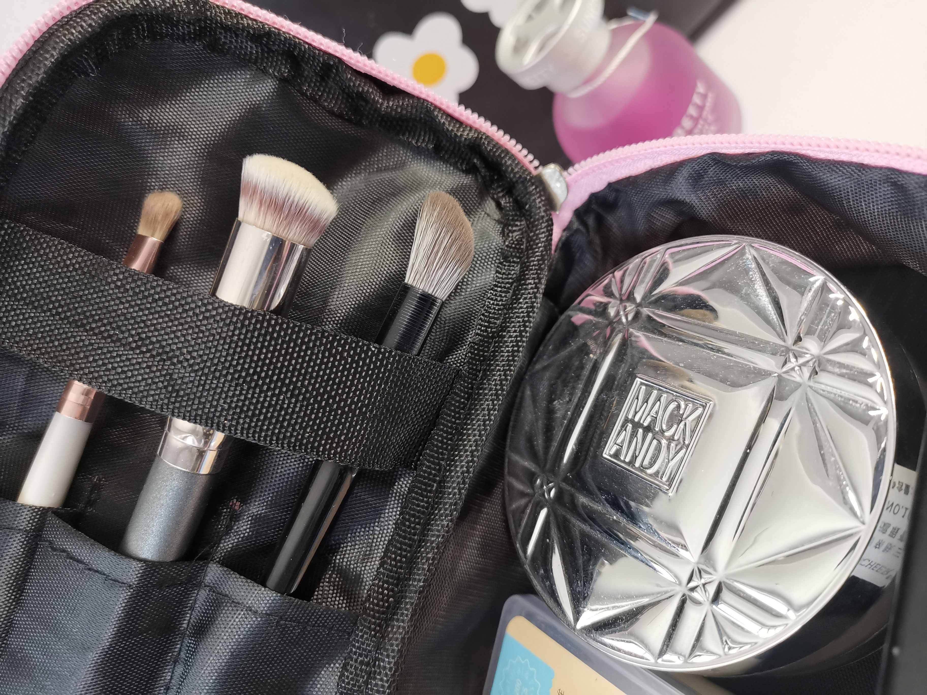 AuraNest double-layer makeup bag with pink polka dots for skincare product storage, showing the open bag with compartments and pink pattern.