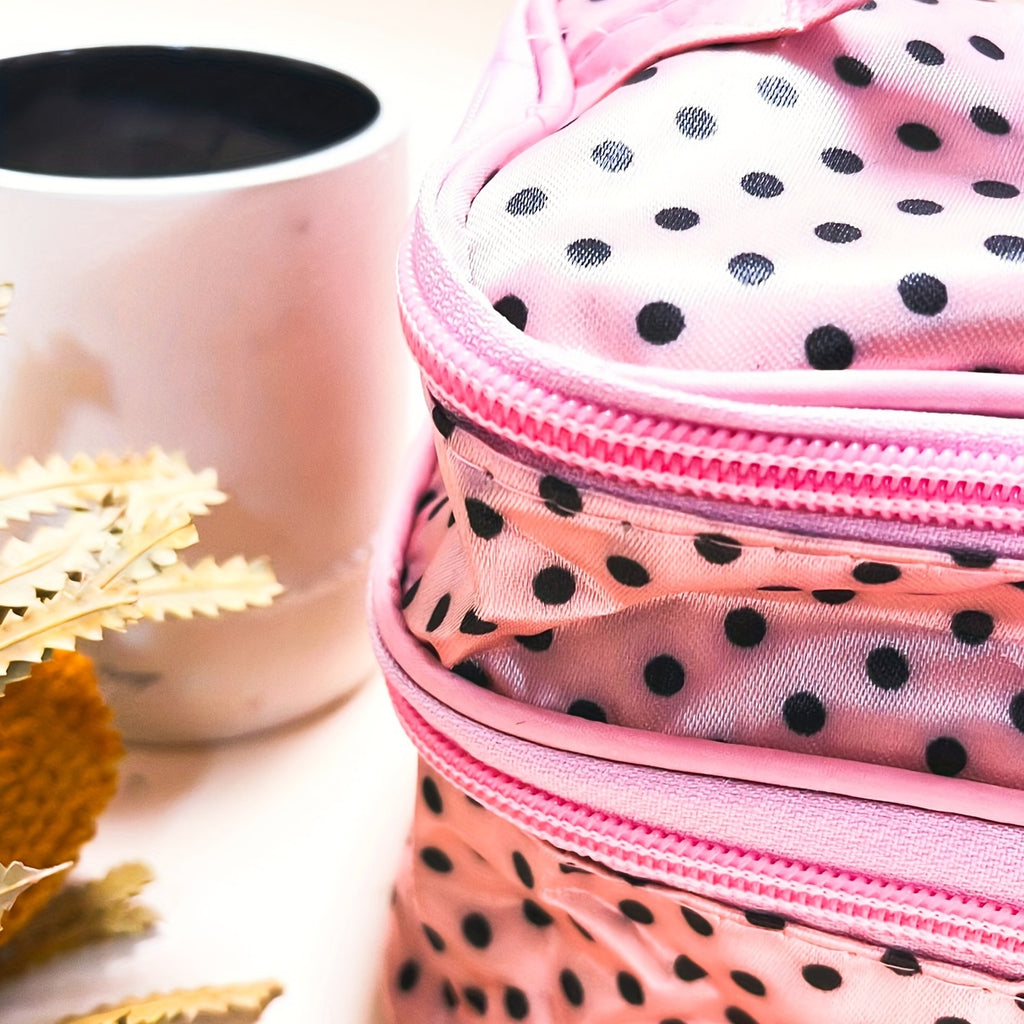 Double-layer pink polka dot makeup bag by AuraNest for storing skincare and makeup products, with zipper closure and compact design.