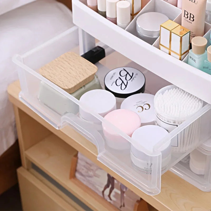 AuraNest plastic cosmetic storage box with clear compartments for organizing makeup and skincare products.