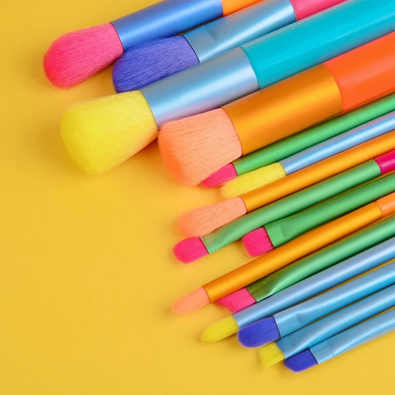 Set of 15 colorful makeup brushes from AuraNest with various brush heads for foundation, eyeshadow, and blending.