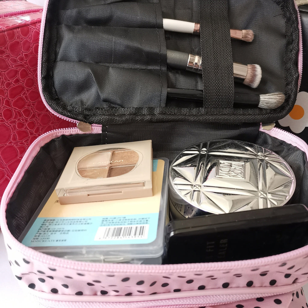 AuraNest double-layer makeup bag with pink polka dots for storing skincare products and cosmetics.